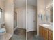 A bathroom with a toilet, shower, vanity, sink, mirror, and lighting at 3818 Chris Dr, Wesley Chapel, FL 33543