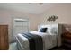 A bedroom with a bed, dresser, ceiling fan and window at 3818 Chris Dr, Wesley Chapel, FL 33543