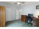 Bright bedroom with a ceiling fan, a desk and computer, as well as ample closet space at 3818 Chris Dr, Wesley Chapel, FL 33543