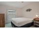 A bedroom with a bed, dresser, ceiling fan and window at 3818 Chris Dr, Wesley Chapel, FL 33543