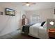 A bedroom with a television, bed, dresser, ceiling fan and window at 3818 Chris Dr, Wesley Chapel, FL 33543