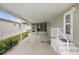 Open carport with access to a screened porch and the main entrance at 3818 Chris Dr, Wesley Chapel, FL 33543