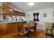 Dining room features wood floors, a table with four chairs, and wooden cabinets at 3818 Chris Dr, Wesley Chapel, FL 33543