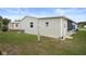 The home's exterior features vinyl siding, green grass, and a screened in porch at 3818 Chris Dr, Wesley Chapel, FL 33543