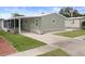 Charming single-story home with tidy lawn, flagpole and covered parking at 3818 Chris Dr, Wesley Chapel, FL 33543