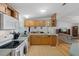 Open kitchen view with wood cabinets, laminate countertops, and white appliances at 3818 Chris Dr, Wesley Chapel, FL 33543