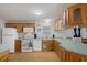 Bright kitchen features wood cabinets, laminate countertops, and white appliances at 3818 Chris Dr, Wesley Chapel, FL 33543