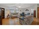 Cozy living room featuring hardwood floors, vaulted ceilings and large windows at 3818 Chris Dr, Wesley Chapel, FL 33543