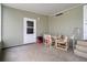 A screened in porch features a table with four chairs and vinyl flooring at 3818 Chris Dr, Wesley Chapel, FL 33543