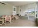 A screened in porch features a table with four chairs, steps, and views of the community at 3818 Chris Dr, Wesley Chapel, FL 33543