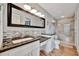 Spa-like bathroom features a tiled shower, granite counters and bright lighting at 3876 Catalina Dr, Bradenton, FL 34210