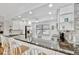 Open kitchen with a breakfast bar, granite countertops, and modern lighting at 3876 Catalina Dr, Bradenton, FL 34210