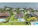 Stunning waterfront home featuring a private pool, lush landscaping, and panoramic ocean views at 3903 Bayside Dr, Bradenton, FL 34210