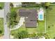 Captivating aerial view of home showcasing lush landscaping, private pool, and inviting outdoor living space at 3903 Bayside Dr, Bradenton, FL 34210