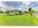 A backyard view of the exterior and pool area on a well-manicured lot at 3903 Bayside Dr, Bradenton, FL 34210