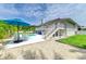 Backyard view of home with pool, stairs to balcony, and patio at 3903 Bayside Dr, Bradenton, FL 34210