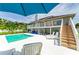 An inviting backyard with pool, sun loungers, and balcony access at 3903 Bayside Dr, Bradenton, FL 34210