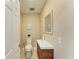 Powder room featuring a vessel sink with a wood vanity, neutral wall paint and decorative art at 3903 Bayside Dr, Bradenton, FL 34210