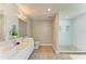 Modern bathroom with double vanity sinks, stylish fixtures, and a glass-enclosed shower with tile accents at 3903 Bayside Dr, Bradenton, FL 34210