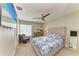 Cozy bedroom featuring blue and white accents, ceiling fan, and relaxing armchair at 3903 Bayside Dr, Bradenton, FL 34210