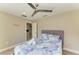Cozy bedroom featuring a blue floral-patterned comforter, ceiling fan and neutral wall color at 3903 Bayside Dr, Bradenton, FL 34210