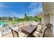 Expansive deck features a dining set, railing with beautiful views of the pool and landscaping at 3903 Bayside Dr, Bradenton, FL 34210