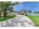 Beautiful home with a long driveway, manicured lawn, mature tree, and a two-car garage at 3903 Bayside Dr, Bradenton, FL 34210