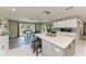 Open kitchen featuring a large island with seating and modern appliances with a dining area and an outdoor view at 3903 Bayside Dr, Bradenton, FL 34210