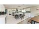 Well-lit kitchen with stainless steel appliances, white cabinetry, island with seating, and modern finishes at 3903 Bayside Dr, Bradenton, FL 34210