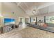 Bright living room featuring a vaulted ceiling, large sectional, and entertainment center with ocean view TV at 3903 Bayside Dr, Bradenton, FL 34210