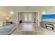 Inviting living room featuring wood-look tile flooring, neutral colors, and French doors leading to the backyard at 3903 Bayside Dr, Bradenton, FL 34210