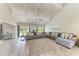 Spacious living room with vaulted ceilings, large sectional sofa, and a cozy neutral rug at 3903 Bayside Dr, Bradenton, FL 34210
