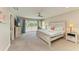 Spacious primary bedroom with a ceiling fan and sliding door access to a private balcony overlooking the outside at 3903 Bayside Dr, Bradenton, FL 34210