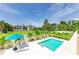 Overhead view showcasing a pool, lounge chairs, and lush landscaping on a bright, sunny day at 3903 Bayside Dr, Bradenton, FL 34210