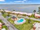 Aerial view featuring community pool and residences near a tranquil waterfront at 4096 El Dorado Cv, Bradenton, FL 34210