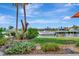 Scenic view of the canal and nearby waterfront homes from the lush backyard, perfect for relaxation and outdoor enjoyment at 4096 El Dorado Cv, Bradenton, FL 34210