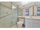 Bathroom featuring a glass-enclosed shower and mosaic tile design at 4096 El Dorado Cv, Bradenton, FL 34210