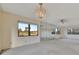 Bedroom featuring ample natural light, a mirrored wall, and neutral carpeting at 4096 El Dorado Cv, Bradenton, FL 34210