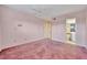 A light-filled bedroom features pink walls and plush, mauve carpeting at 4096 El Dorado Cv, Bradenton, FL 34210