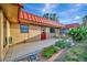 Tan-colored house exterior with a red metal roof, brick patio, and well-maintained landscaping at 4096 El Dorado Cv, Bradenton, FL 34210