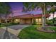 Charming home with a red roof, well-maintained lawn, and mature trees create a welcoming curb appeal at 4096 El Dorado Cv, Bradenton, FL 34210