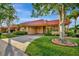 Charming home with a red roof, well-maintained lawn, and mature trees create a welcoming curb appeal at 4096 El Dorado Cv, Bradenton, FL 34210
