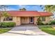 Inviting home showcasing a well-manicured lawn, a red roof, and a paved driveway leading to the covered entrance at 4096 El Dorado Cv, Bradenton, FL 34210