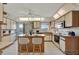 Spacious kitchen features island with breakfast bar, white cabinets and stainless appliances at 4096 El Dorado Cv, Bradenton, FL 34210