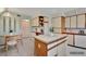 Bright kitchen features an island with tile countertop and dining area at 4096 El Dorado Cv, Bradenton, FL 34210