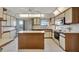 Spacious kitchen features island with breakfast bar, white cabinets and stainless appliances at 4096 El Dorado Cv, Bradenton, FL 34210