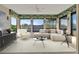 Bright sunroom features large windows with waterfront views and stylish, neutral decor at 4096 El Dorado Cv, Bradenton, FL 34210