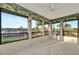 Bright sunroom with many windows showing a serene waterfront view at 4096 El Dorado Cv, Bradenton, FL 34210