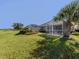 Lush backyard with screened lanai and tropical landscaping, perfect for outdoor living at 4153 Fairway Dr, North Port, FL 34287