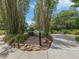 Secluded walkway featuring bamboo, greenery, and a small stone waterfall at 4153 Fairway Dr, North Port, FL 34287